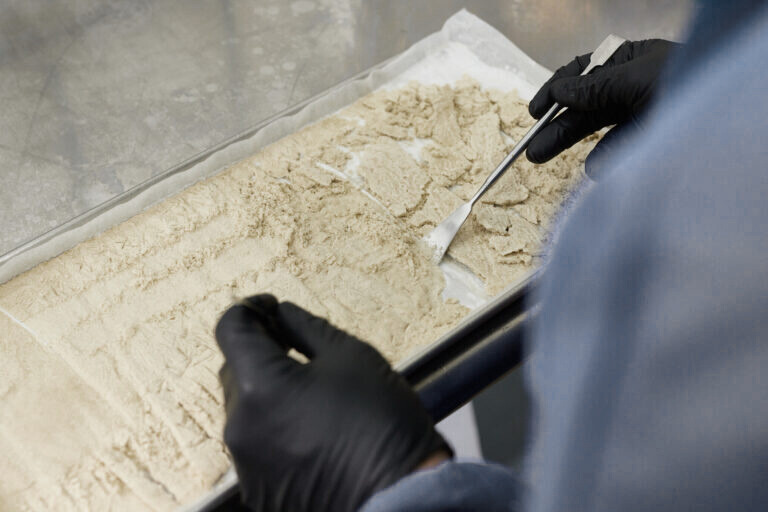 man creating hash in a tray.
